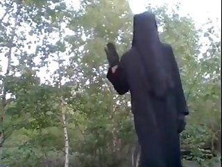 Utendørs In niqab showing nylon legs.